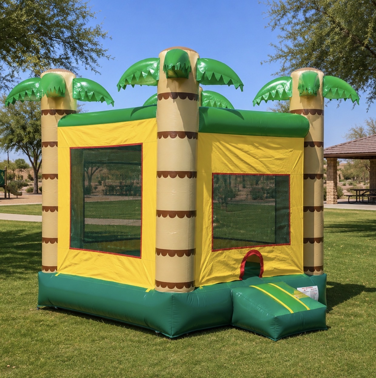 Tropical bounce house rental with palm-tree columns